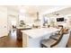 Open kitchen with large island, stainless appliances, and view to living area and staircase at 765 Glengate Pl, Atlanta, GA 30328