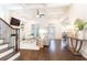 Spacious living room with high ceilings, a staircase, dark floors, and a view into the kitchen area at 765 Glengate Pl, Atlanta, GA 30328
