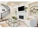 Chic living room with a fireplace, built-in shelves, elegant decor, and staircase access to the second floor at 765 Glengate Pl, Atlanta, GA 30328