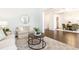 Inviting living room with hardwood floors, comfortable seating, a round mirror, and an open dining area at 765 Glengate Pl, Atlanta, GA 30328