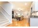 The living room features wood floors, stairs, a small bar with a wine cooler, and neutral decor at 765 Glengate Pl, Atlanta, GA 30328