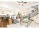 Open-concept living room flows into kitchen, featuring hardwood floors, fireplace, and staircase at 765 Glengate Pl, Atlanta, GA 30328