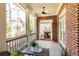 Charming screened porch with brick accents, ceiling fan, and view to the dining room at 765 Glengate Pl, Atlanta, GA 30328