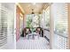 Relaxing screened-in porch featuring wicker seating, ceiling fans, and serene views at 765 Glengate Pl, Atlanta, GA 30328