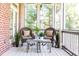 Inviting screened-in porch with wicker chairs and table, perfect for outdoor relaxation at 765 Glengate Pl, Atlanta, GA 30328