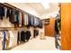 Spacious walk-in closet with custom shelving, hanging racks, and a full-length mirror providing ample storage at 765 Glengate Pl, Atlanta, GA 30328
