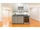 Stylish wet bar featuring granite countertops, gray cabinets, and a wine refrigerator at 765 Glengate Pl, Atlanta, GA 30328
