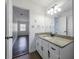 Bathroom featuring granite countertop vanity, white cabinets, and tile floors at 857 Winding Trl, Lawrenceville, GA 30046