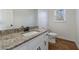 Bathroom featuring granite countertop, hardwood floors, white cabinets, sink, and a toilet at 857 Winding Trl, Lawrenceville, GA 30046