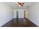 Empty bedroom featuring hardwood floors, neutral decor, natural light, and ceiling fan at 857 Winding Trl, Lawrenceville, GA 30046