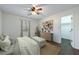 Bedroom featuring ceiling fan, closet access, and a large window at 857 Winding Trl, Lawrenceville, GA 30046