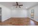 Sunny dining room boasts hardwood floors, wainscoting and an oversized window at 857 Winding Trl, Lawrenceville, GA 30046
