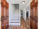 Bright foyer with hardwood floors, staircase, and view into dining area at 857 Winding Trl, Lawrenceville, GA 30046