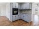 Well-equipped kitchen features gray cabinets, granite countertops, tiled backsplash, and stainless steel appliances at 857 Winding Trl, Lawrenceville, GA 30046