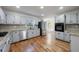 Well-lit kitchen features stainless steel appliances, granite countertops, and hardwood floors at 857 Winding Trl, Lawrenceville, GA 30046