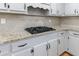 Modern kitchen features granite countertops, white cabinetry, tiled backsplash, and a gas cooktop at 857 Winding Trl, Lawrenceville, GA 30046