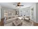 Bright living room featuring large windows, hardwood floors, and a ceiling fan at 857 Winding Trl, Lawrenceville, GA 30046