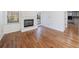 Cozy living room featuring a fireplace, hardwood floors, and access to the backyard at 857 Winding Trl, Lawrenceville, GA 30046