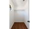 Walk-in closet featuring hardwood floors, a small window, and clothing racks at 857 Winding Trl, Lawrenceville, GA 30046