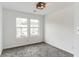 Cozy bedroom with soft carpet and ample natural light streaming through two windows at 4011 Redan Rd # 6, Stone Mountain, GA 30083