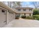 Two story house featuring attached two car garage, stone accents and a well maintained front yard at 7405 Princeton Trce, Atlanta, GA 30328