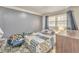 Simple bedroom with gray walls, a bed covered in a patterned quilt, and blue curtains at 283 Reynolds Bridge Rd, Kingston, GA 30145