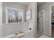 Bright bathroom with a soaking tub under a window and a separate glass-enclosed shower at 5211 Centennial Hill Nw Dr, Acworth, GA 30102