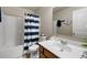 Bathroom with striped shower curtain at 5211 Centennial Hill Nw Dr, Acworth, GA 30102