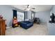 Cozy bedroom features blue walls, carpet floors, natural light, ceiling fan, and additional sitting area at 5211 Centennial Hill Nw Dr, Acworth, GA 30102