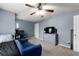 Bedroom featuring light blue walls, carpet, ceiling fan, and a comfortable seating arrangement at 5211 Centennial Hill Nw Dr, Acworth, GA 30102