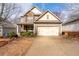 Charming two-story home with a stone facade, a well-manicured lawn and a two-car garage at 5211 Centennial Hill Nw Dr, Acworth, GA 30102