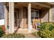 Inviting front porch featuring stacked stone accents and a classic rocking chair, perfect for relaxing outdoors at 5211 Centennial Hill Nw Dr, Acworth, GA 30102