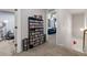Hallway with neutral carpet, door to other bedrooms, and view of the living room at 5211 Centennial Hill Nw Dr, Acworth, GA 30102