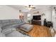 Comfortable living room featuring hardwood floors, a large sectional sofa, and plenty of natural light at 5211 Centennial Hill Nw Dr, Acworth, GA 30102