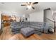 Open-concept living room with hardwood floors and large sectional couch at 5211 Centennial Hill Nw Dr, Acworth, GA 30102