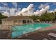 Community swimming pool with chairs and landscaped surroundings on a sunny day at 5211 Centennial Hill Nw Dr, Acworth, GA 30102