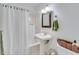 Classic bathroom with pedestal sink, shower-tub combo, and neutral decor at 7875 Robin Rd, Cumming, GA 30041