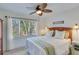Relaxing bedroom with a ceiling fan and large windows that fill the room with natural light at 7875 Robin Rd, Cumming, GA 30041