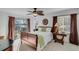 Bright bedroom with ceiling fan, lake view, and a decorative accent wall at 7875 Robin Rd, Cumming, GA 30041
