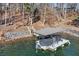 A private covered boat dock equipped with a boat lift, offering direct access to the serene waterfront at 7875 Robin Rd, Cumming, GA 30041
