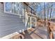 A beautiful home exterior featuring a spacious wooden deck and large sliding glass doors at 7875 Robin Rd, Cumming, GA 30041