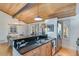 Charming kitchen features black granite countertop, stainless appliances, and wood-clad ceiling at 7875 Robin Rd, Cumming, GA 30041