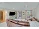 Cozy living room with a plush leather sofa, entertainment center, and natural light at 7875 Robin Rd, Cumming, GA 30041