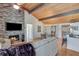 Inviting living room features a stone fireplace, wood ceiling, and hardwood floors at 7875 Robin Rd, Cumming, GA 30041