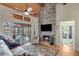 Living area with stone fireplace and access to screened-in porch at 7875 Robin Rd, Cumming, GA 30041