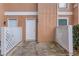 A townhouse exterior featuring a secure front door and a private, fenced entrance patio at 2340 Beaver Ruin Rd # Un62, Norcross, GA 30071