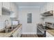 Bright kitchenette features white cabinets, stainless steel appliances, and granite countertops at 2340 Beaver Ruin Rd # Un62, Norcross, GA 30071