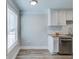 Bright kitchenette features white cabinets, stainless steel appliances, and granite countertops at 2340 Beaver Ruin Rd # Un62, Norcross, GA 30071