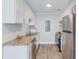 Bright kitchenette features white cabinets, stainless steel appliances, and granite countertops at 2340 Beaver Ruin Rd # Un62, Norcross, GA 30071