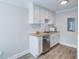 Bright kitchenette features white cabinets, stainless steel appliances, and granite countertops at 2340 Beaver Ruin Rd # Un62, Norcross, GA 30071